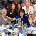 Several authors by a table.