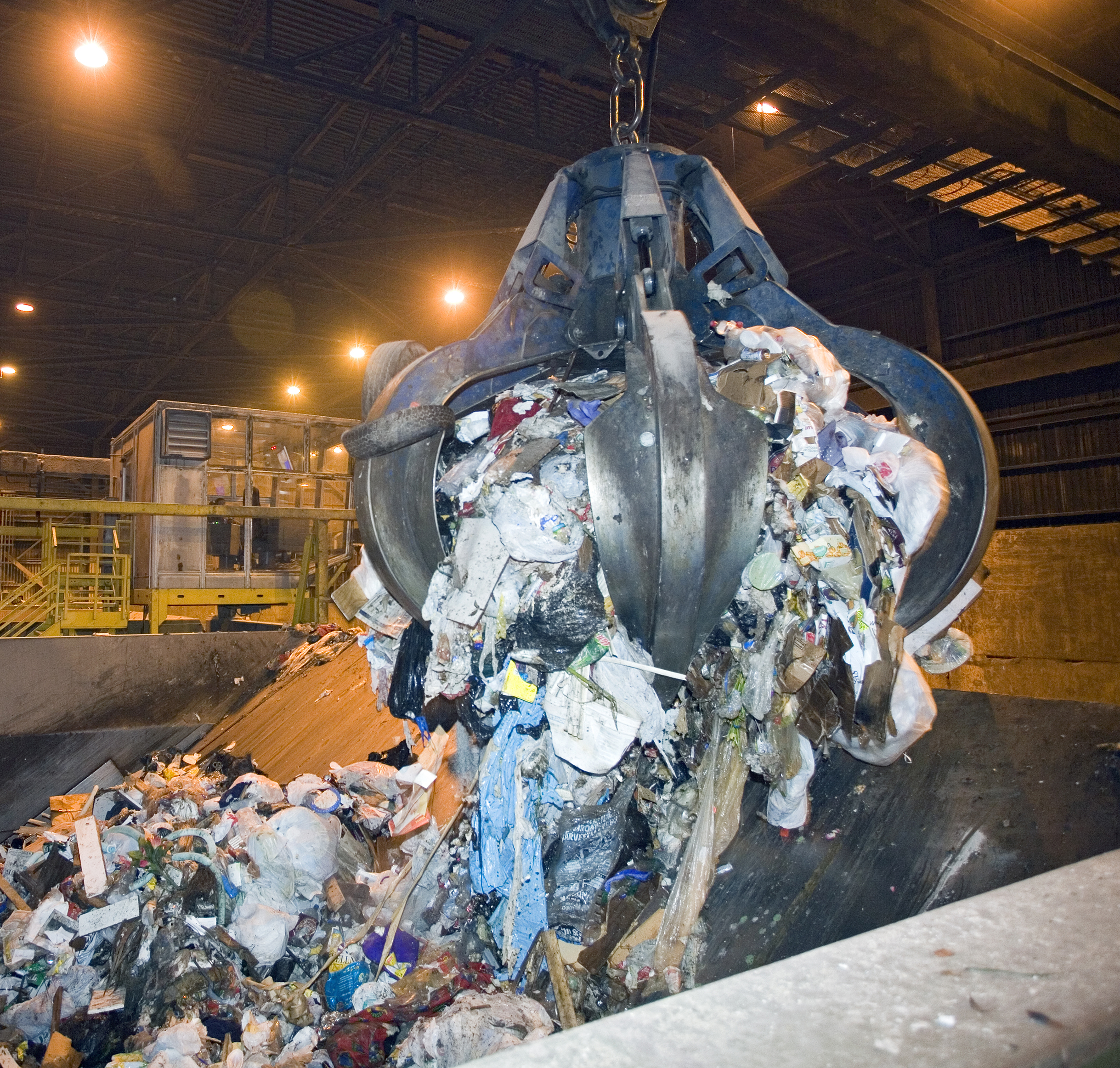 Grapple Crane Loading Garbage into Hopper.jpg